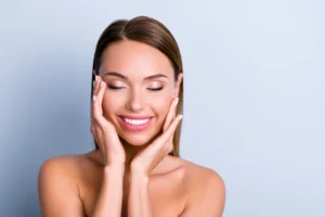 Woman smiling with glowing skin after PDO threads treatment.
