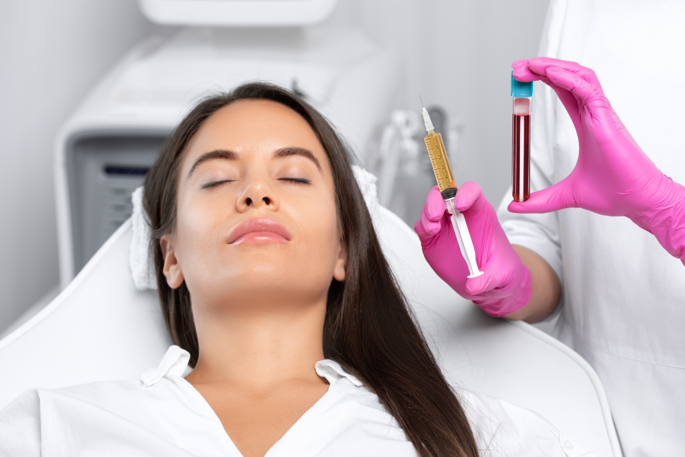 Woman undergoing PRP vampire facial session with syringe and blood vial visible.