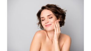 A woman smiling with rejuvenated skin after injectables.